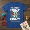 Blue t-shirt with white text "YES, I'M WITH CRAZY CRAZY" and a cartoon white dog wearing sunglasses and a cape