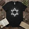 Black t-shirt with white "YESHUA" text inside a Star of David graphic, surrounded by radiating lines