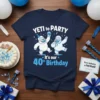 YETI to PARTY It's our 40th Birthday text with two cartoon yetis celebrating, on a navy blue t-shirt