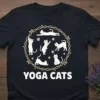 Black t-shirt featuring white cats in various yoga poses arranged in a circular pattern with the text "YOGA CATS" below