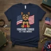 Yorkshire Terrier sitting in front of an American flag with text "YORKSHIRE TERRIER EST. 1700s AMERICA"