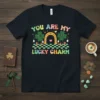 You Are My Lucky Charm t-shirt with cartoon shamrocks, a horseshoe, and colorful retro text for St. Patrick's Day