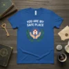 YOU ARE MY SAFE PLACE quote on a blue t-shirt with hands holding a house graphic and laurel wreath