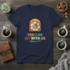 Christian t-shirt with text "YOU CAN SIT WITH US Romans 15:7" and a graphic of diverse hands joining together