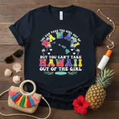 T-shirt with colorful text "You Can Take The Girl Out Of Hawaii But You Can't Take Hawaii Out Of The