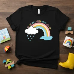 You Can't Have A Rainbow Without A Little Rain quote t-shirt with a colorful rainbow and rain cloud graphic