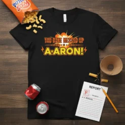 Black t-shirt with orange and yellow text "YOU DONE MESSED UP AARON!" in a comic book style, featuring lightning bolts