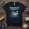 Navy t-shirt with white and blue text "YOU DON'T HAVE TO BE CRAZY To cruise whit us WE CAN TRAIN