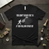 Black t-shirt with white text "YOU DON'T REACH THE 1% IF YOU FOLLOW OTHER 99" and graphic of people running