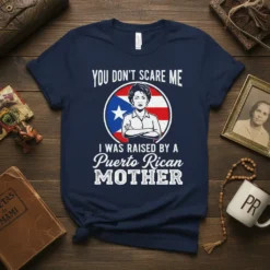 T-shirt featuring the text "YOU DON'T SCARE ME I WAS RAISED BY A Puerto Rican MOTHER" with a portrait and