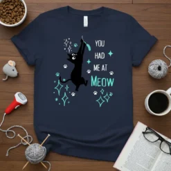 Navy t-shirt with "You Had Me At Meow" text and a black cat design, featuring paw prints and sparkles