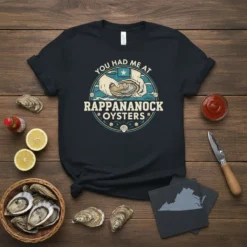 T-shirt with "You Had Me At Rappahannock Oysters" text and graphic of hands holding an oyster, depicting coastal theme