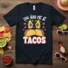 Cute "You Had Me At Tacos" t-shirt design with smiling avocados and tacos, surrounded by pink hearts