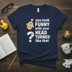Navy t-shirt with white text saying "you look FUNNY with your HEAD TURNED like that" and a cartoon head illustration