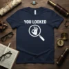 Navy blue t-shirt with white text "YOU LOOKED" and an OK hand symbol inside a magnifying glass graphic