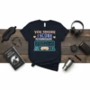 Navy t-shirt with "You Snore I Score Polysomnography" text and a graphic of a polysomnography machine with a sleeping mask