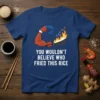 Funny t-shirt with text "YOU WOULDN'T BELIEVE WHO FRIED THIS RICE" and a cartoon crab claw cooking in a wok