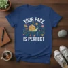 Your Pace Is Perfect quote with a cute snail and floral design on a navy blue t-shirt