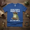 T-shirt with the quote "You're Either A Smart Fella Or A Fart Smella" featuring a frog wearing a cowboy hat