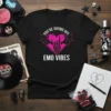 Black t-shirt with pink text "You're Giving Off Emo Vibes" and a heart graphic with bat wings and skeleton hands