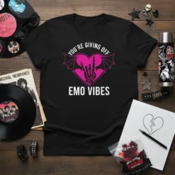 Black t-shirt with pink text "You're Giving Off Emo Vibes" and a heart graphic with bat wings and skeleton hands