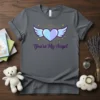 Gray t-shirt with a light blue heart and white wings design, text "You're My Angel" below