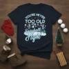 You're Never Too Old For A Snowball Fight T-Shirt with cartoon kids throwing snowballs, snowflakes, and festive winter theme