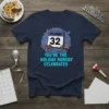 T-shirt with "December 32 You're The Holiday Nobody Celebrates" text and festive graphics, including a calendar, gift, and party hat