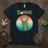 Zombie Rock Hand T-Shirt design with the word "Zombie" in a horror-themed font and a green zombie hand giving the