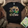 Zoo Crew t-shirt design with animal print letters, safari hat, giraffe, binoculars, and camera graphic
