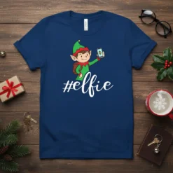 #elfie hashtag text with a cartoon elf taking a selfie on a dark blue t-shirt