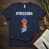 Navy t-shirt with #FREECUBA hashtag above a graphic of an orange fist breaking chains, symbolizing freedom for Cuba