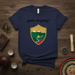 "HMON ANGMOT+" text above a shield with mountains, river, and a star on a navy t-shirt