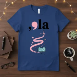 Blue ,ola literary quote t-shirt with a pink comma and 'la' text above an open book, pink swirl, and stars