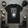 Black t-shirt with white text "BADASS PITBULL" and a graphic of a pitbull head with crossed bones