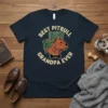 Best Pitbull Grandpa Ever text with a pitbull wearing glasses sitting in a chair graphic on a navy t-shirt