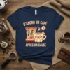 French text "D'ABORD UN CAFÉ APRÈS ON CAUSE" with a bulldog drinking coffee design on a navy t-shirt