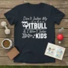 Don't Judge My PITBULL & I Won't Judge YOUR KIDS text with a sunglasses-wearing pitbull graphic on a navy t-shirt