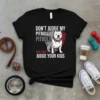 Black t-shirt with "Don't Judge My Pitbull Pitbull And I Won't Judge Your Kids" text and a graphic of a