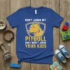 T-shirt with "Don't Judge My Pitbull And I Won't Judge Your Kids" quote and pitbull head graphic