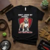 Black t-shirt featuring the quote "DON'T JUDGE MY PITBULL AND I WON'T WON'T JUDGE YOUR KIDS" with a graphic of