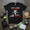 Black t-shirt with white and red text "DON'T JUDGE MY PITBULL AND I WON'T JUDGE YOUR KIDS" and a graphic