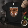 Black t-shirt with "DON'T TOUCH MY PITTIES" text and two pitbull dog heads in a shield graphic