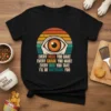 Black t-shirt with retro sunset graphic and text "EVERY MEAL YOU BAKE EVERY SNACK YOU MAKE EVERY BITE YOU TAKE