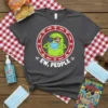 Ew, People t-shirt with a cartoon germ character wearing sunglasses and a face mask. The text "EW, PEOPLE" is prominent