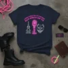 Navy t-shirt with pink neon text "Good Girls Go To Church Bad Girls Go To" above graphics of a church