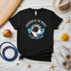 Guardian Of The Waves Pit Bull Surf Club t-shirt featuring a pit bull head inside a circular logo with waves
