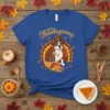 Happy Thanksgiving Dog T-Shirt with a pitbull dressed as a turkey, wearing a pilgrim hat and holding a bone
