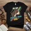 In My Pitbull Mom Era text with a pitbull dog graphic on a black t-shirt, retro style