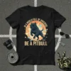 Black pitbull wearing sunglasses with text "In A World Full Of Unicorns Be A Pitbull" graphic tee